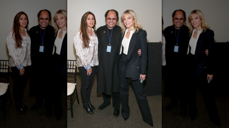 Marla Maples wears a blazer while speaking into a microphone