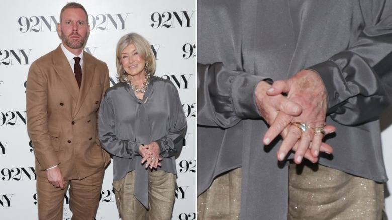 Martha Stewart holding up a book with a man in a brown suit