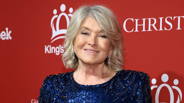Martha Stewart in a blue sequin gown in front of a red background