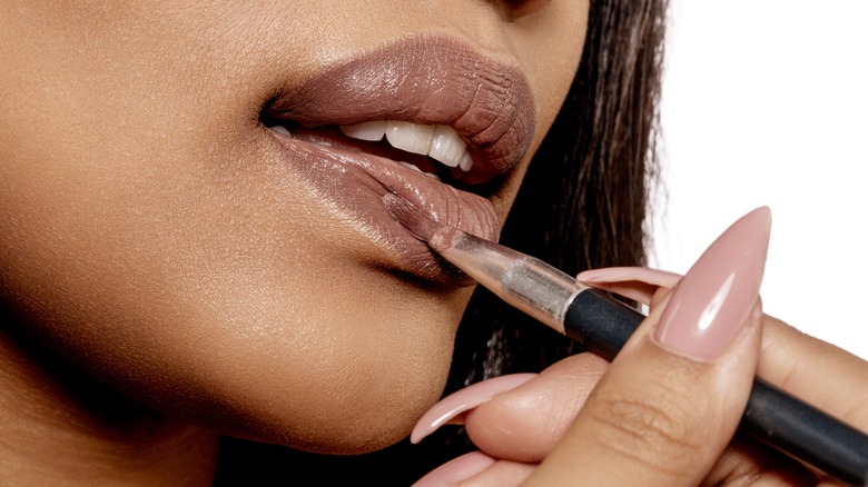 Applying lipstick