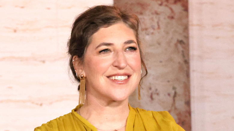 Mayim Bialik on red carpet, smiling