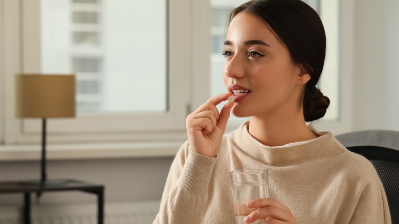 woman takes pill