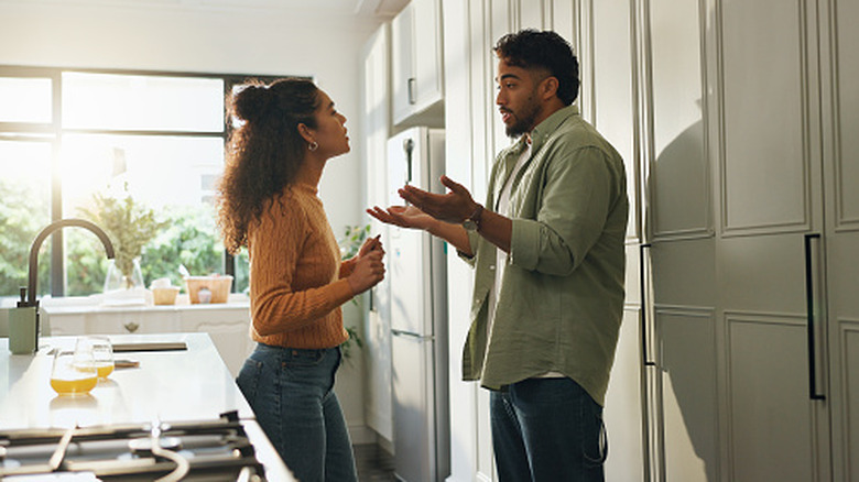 Man and woman having an argument in a kitchen