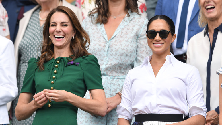 Kate Middleton and Meghan Markle in the stands at a sporting event