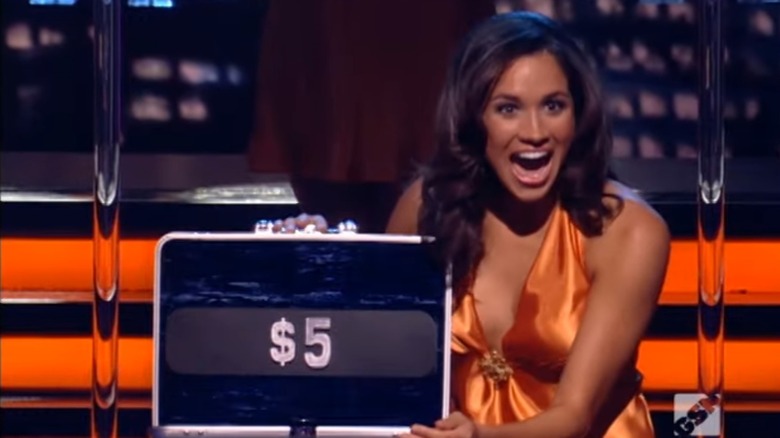 Meghan Markle with a shocked face after opening a briefcase on "Deal or No Deal"