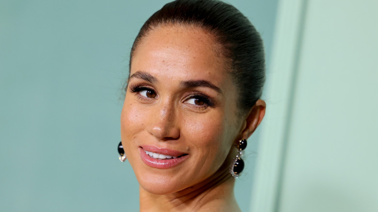 Meghan Markle smiles on the red carpet in 2026