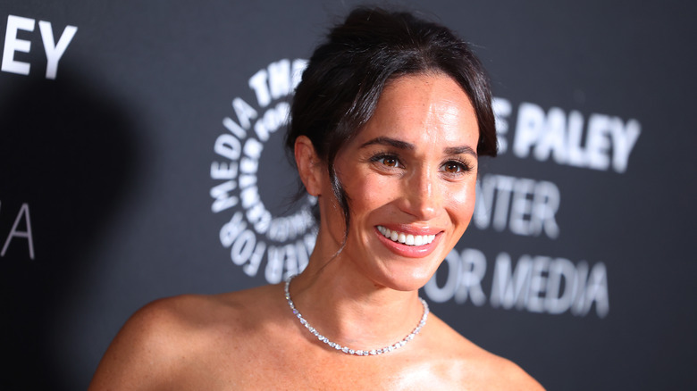 Meghan Markle smiles on the red carpet in 2024