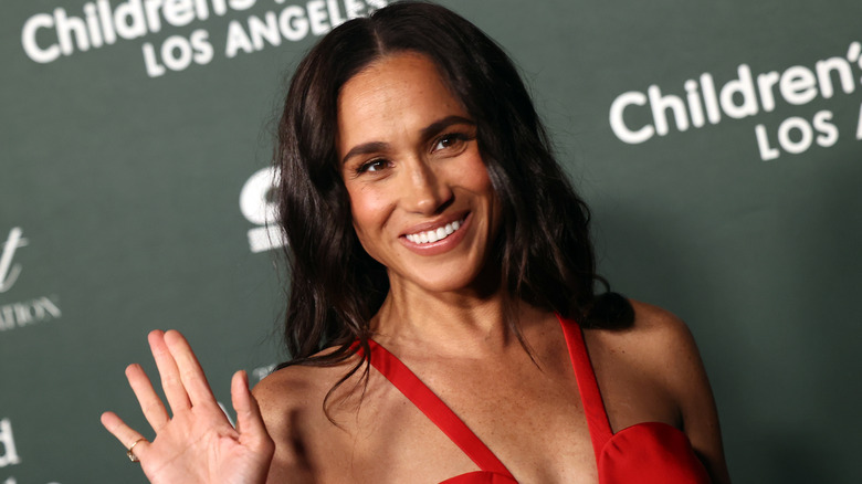 Meghan Markle smiles on the red carpet in 2024