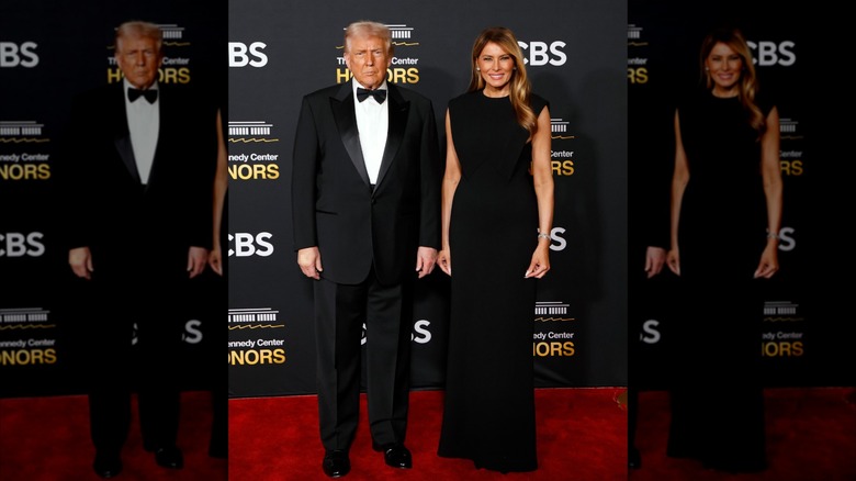 Melania Trump wearing a simple black dress on the red carpet with Donald Trump