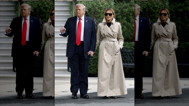Melania Trump walking alongside Donald Trump and wearing a long trench coat