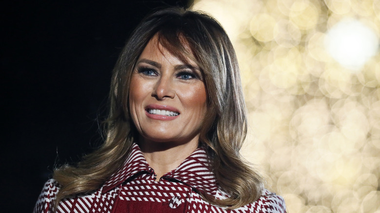 Melania Trump in a red and white coat at an event