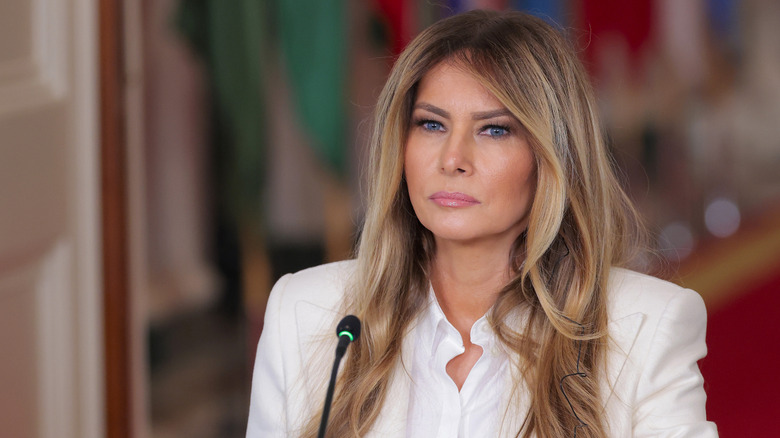 Melania Trump in a white blazer and white top