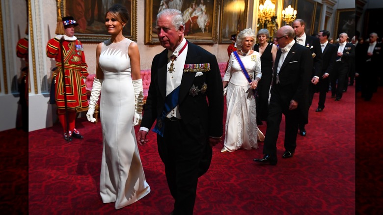 Melania Trump wearing a long, white dress and long gloves