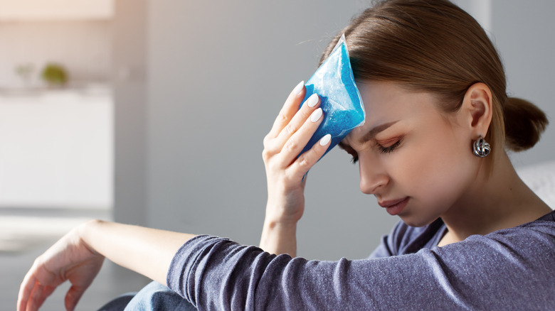 Woman holds ice pack