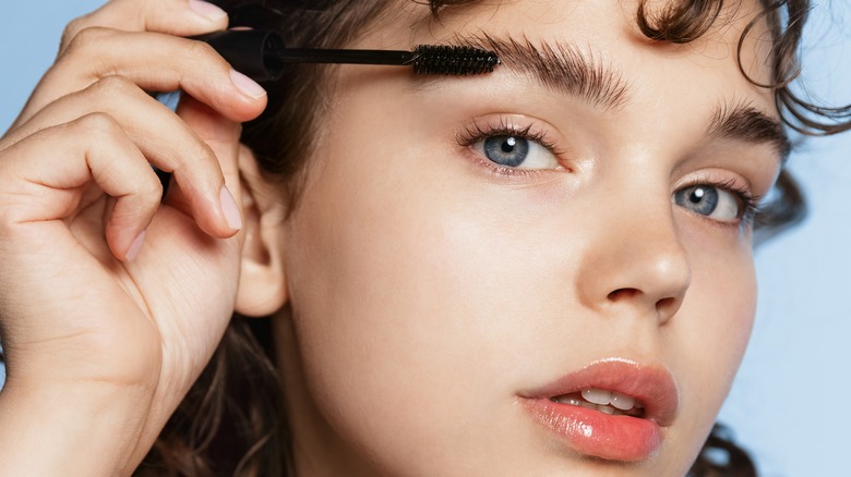 Woman applying product on her brows