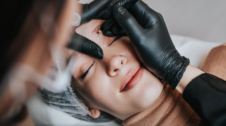 Woman undergoing microblading treatment