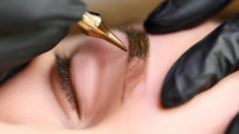 Woman undergoing microblading treatment
