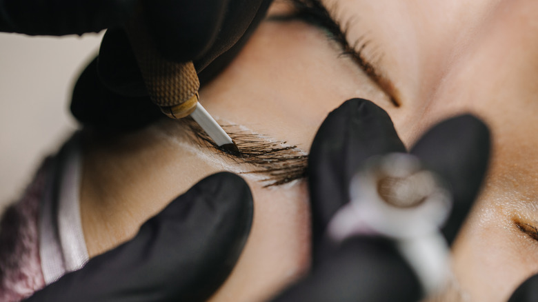 Woman undergoing microblading treatment