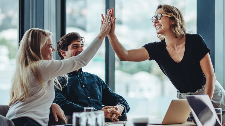 Women high-fiving