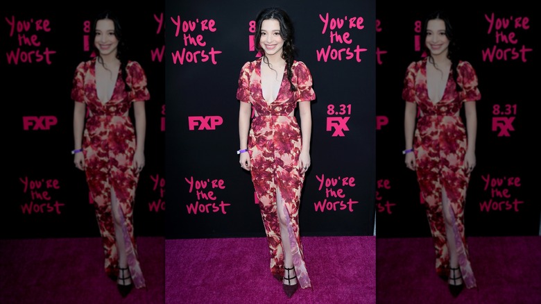 Mikey Madison posing in a floral maxi dress at an FX premiere