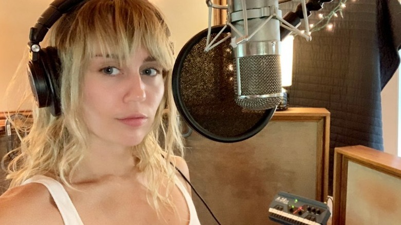 Miley Cyrus taking a selfie in the recording studio
