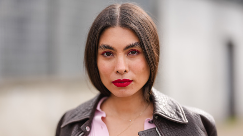 Woman wearing red lipstick with super-fluffed eyebrows
