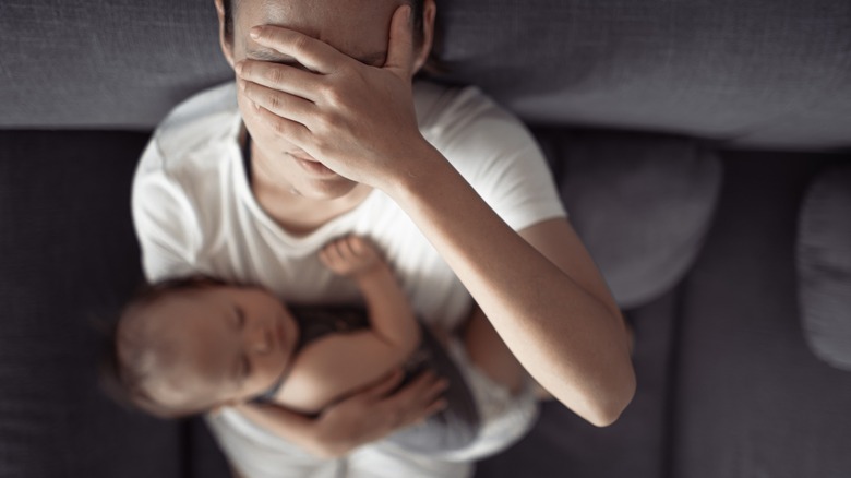 Stressed woman holding baby