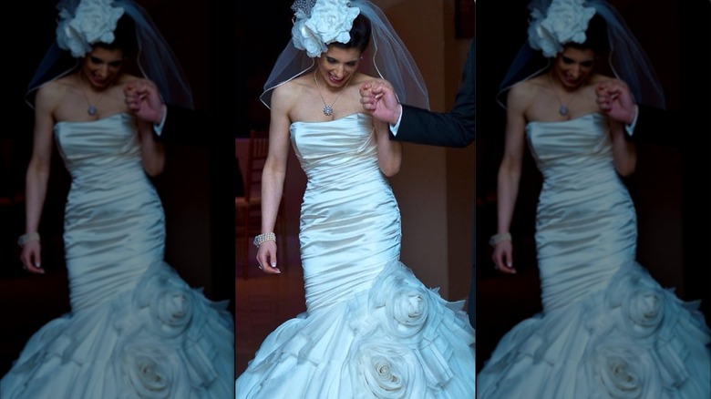 A 2010 bride in a drop-waist mermaid gown with a floral headpiece