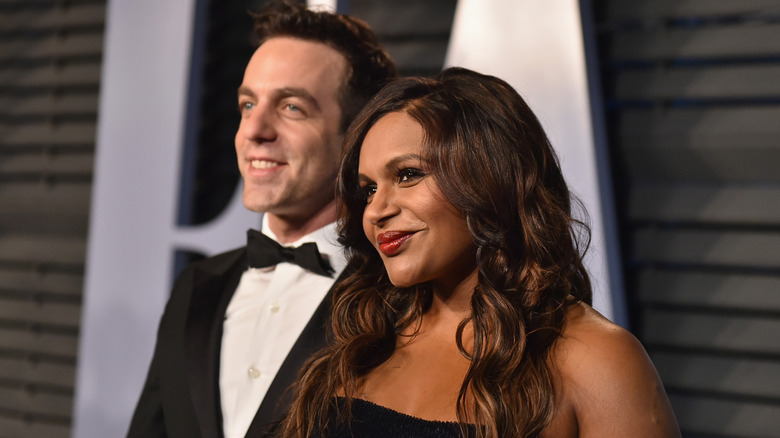 Mindy Kaling standing in front of BJ Novak on the red carpet