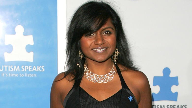 Mindy Kaling in a black dress and bold jewelry on the red carpet in 2005
