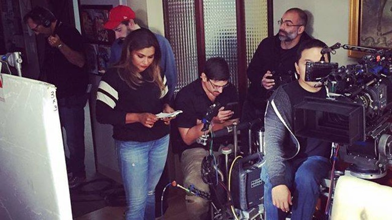 Mindy Kaling standing with crew on the set of The Mindy Project