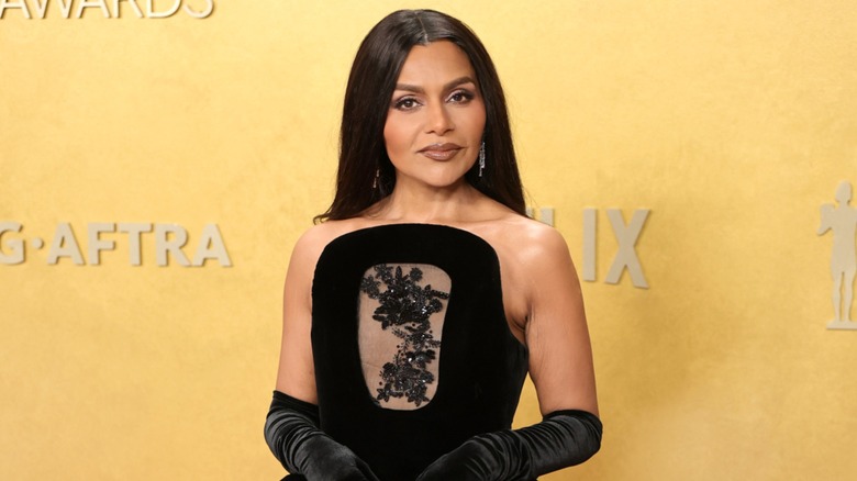 Mindy Kaling wearing a strapless, black dress on the red carpet at the 2026 Actor Awards