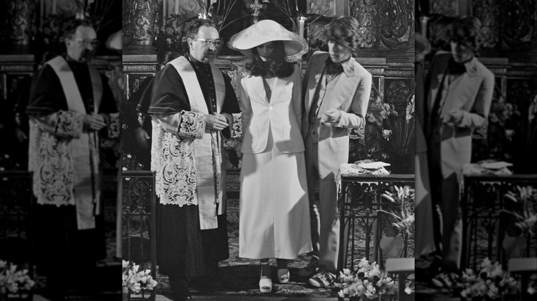 Bianca Jagger and Mick Jagger with a priest on their wedding day