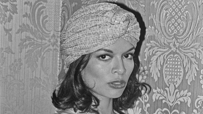 Bianca Jagger in a head turban at an event
