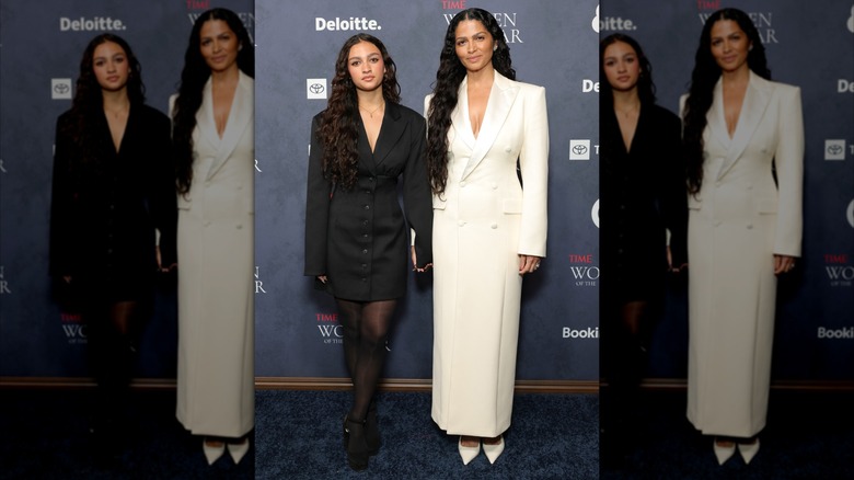 Vida and Camila McConaughey holding hands while wearing coordinated menswear-inspired dresses