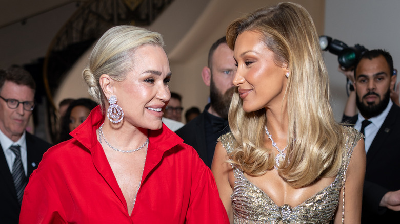 Mother and daughter Yolanda and Bella Hadid smiling at each other while attending a Cannes Film Festival event