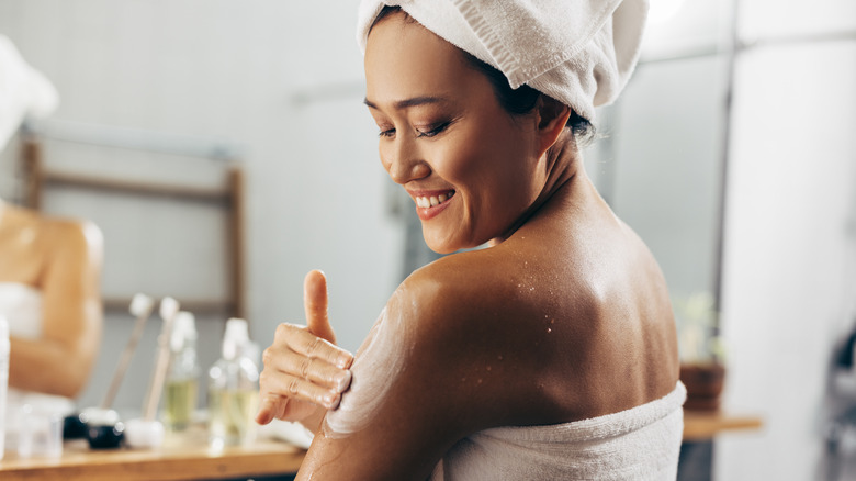 Woman using moisturizer