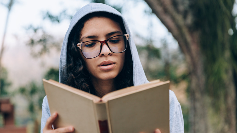 Woman reading a book intently