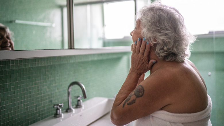 Woman applying moisturizer