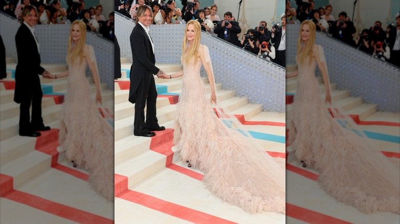Nicole Kidman on the Met Gala steps in a pale pink gown with a cascading train