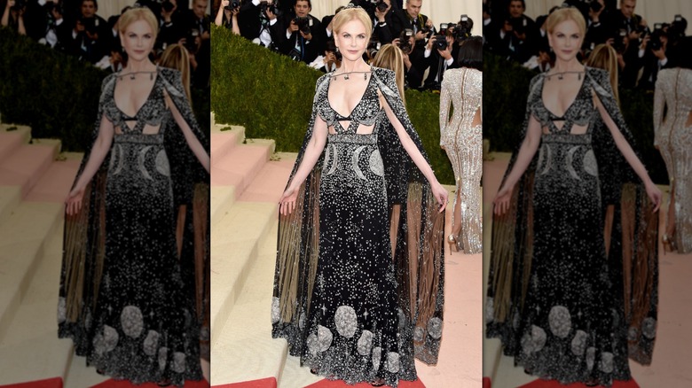 Nicole Kidman at the Met Gala in a black gown with silver details and a sheer cape