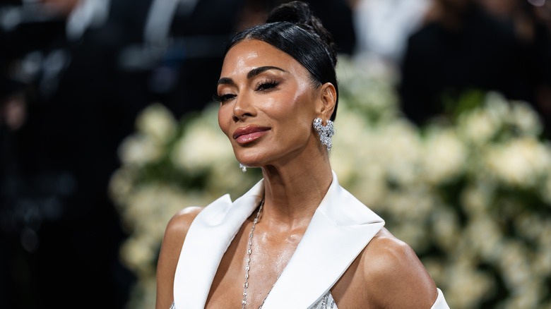 Nicole Scherzinger wearing statement earrings and a white collar on the red carpet