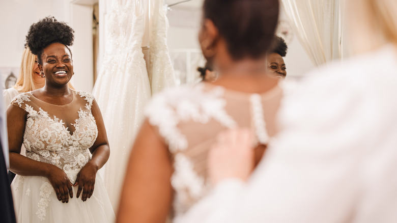 Woman trying on wedding dress 