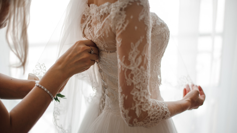 Woman trying on a wedding dress 