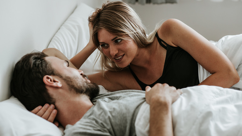 couple laying in bed talking