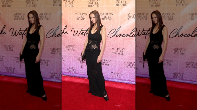 Katie Holmes wearing a black crochet dress with black patent ballerina flats