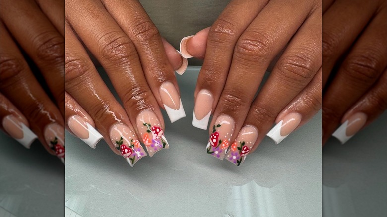 Two hands showing a mushroom nail design with classic square French tips