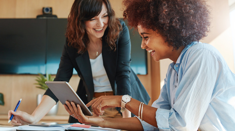 two women laughing at work