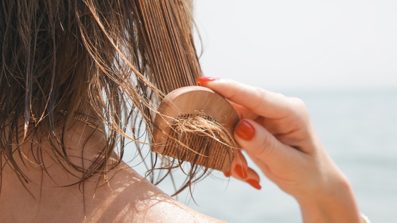 A woman combing her hair