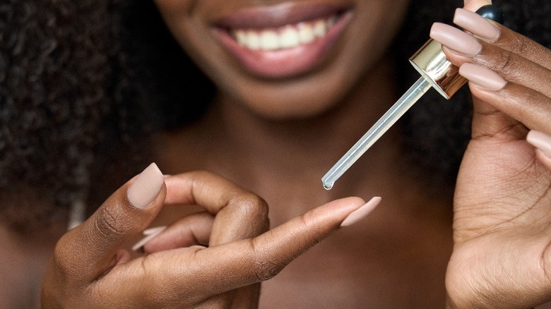 Woman applying serum